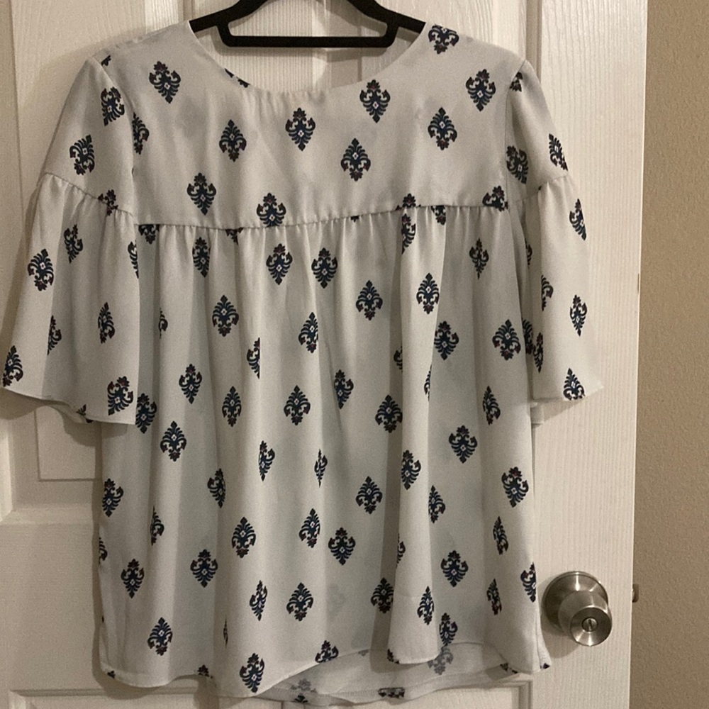 Loft blouse size small. Cream background with blue and red print.